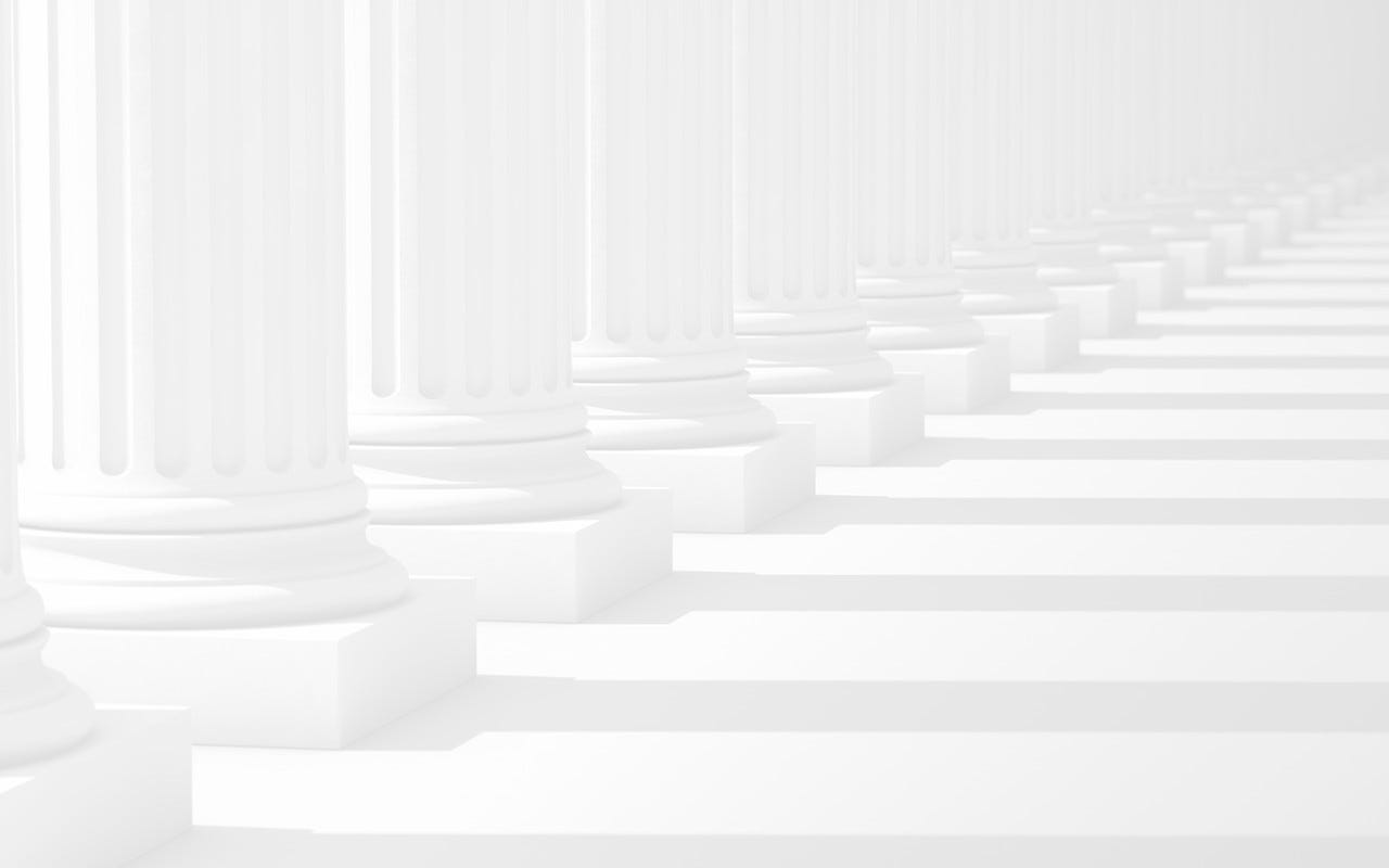 A row of columns diminishes to the vanishing point and out of focus.Computer Generated for perfect shadow angles and crisp columns.